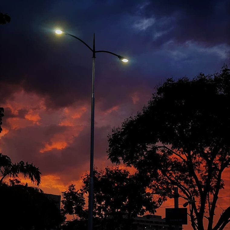 Streetlight against a burning sky
